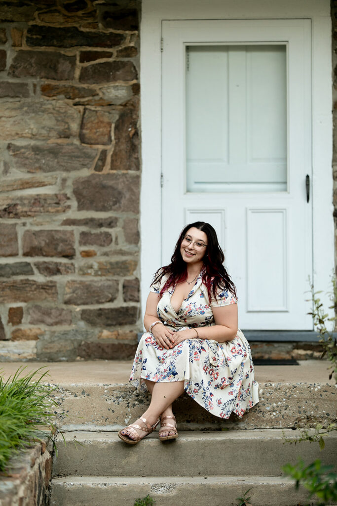 Woman sitting on the historic stone steps at John Rudy Park during an outdoor portrait session in York, PA. John Rudy Park portraits